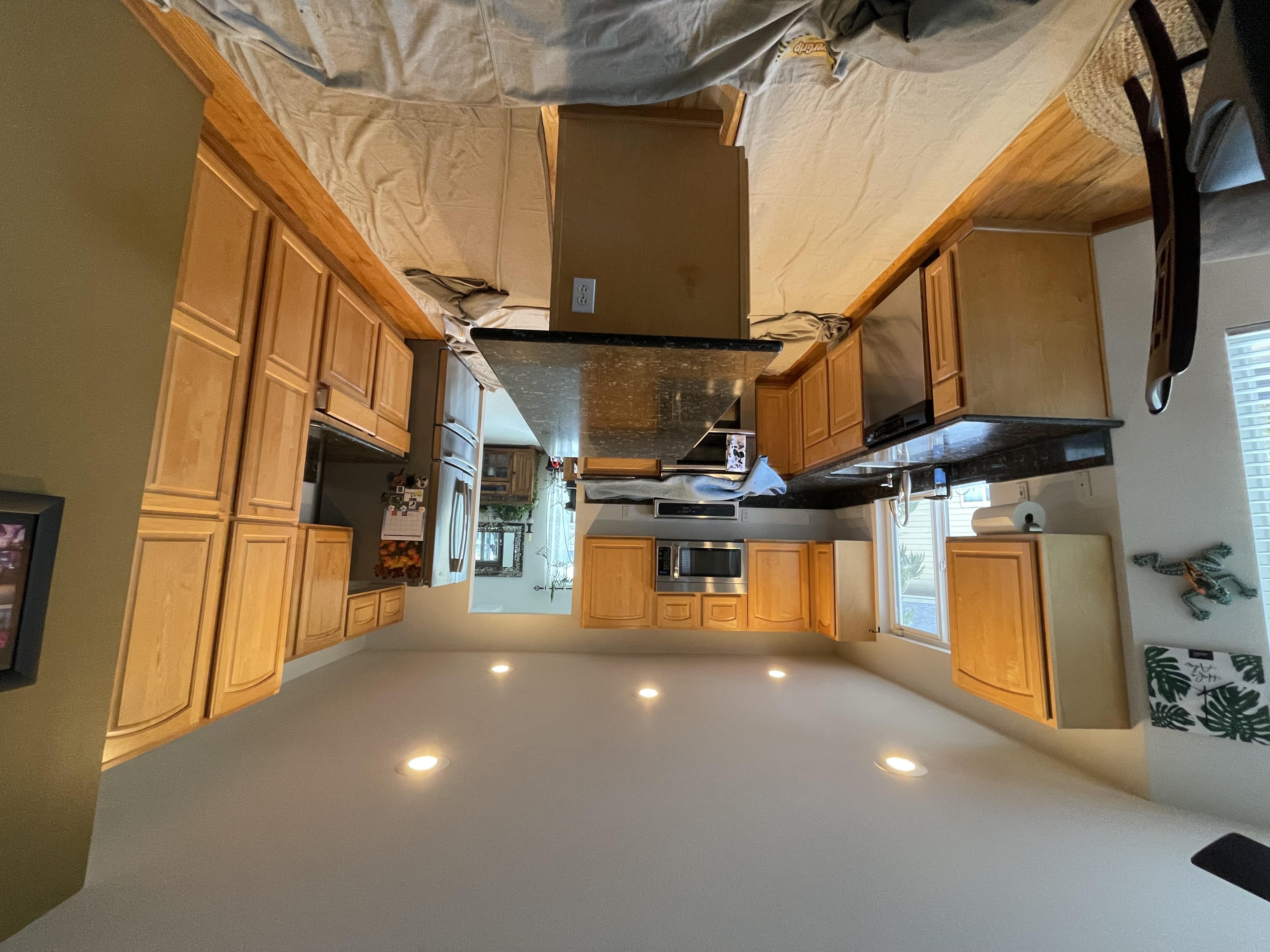 Kitchen before refacing with natural wood raised-panel cabinet doors